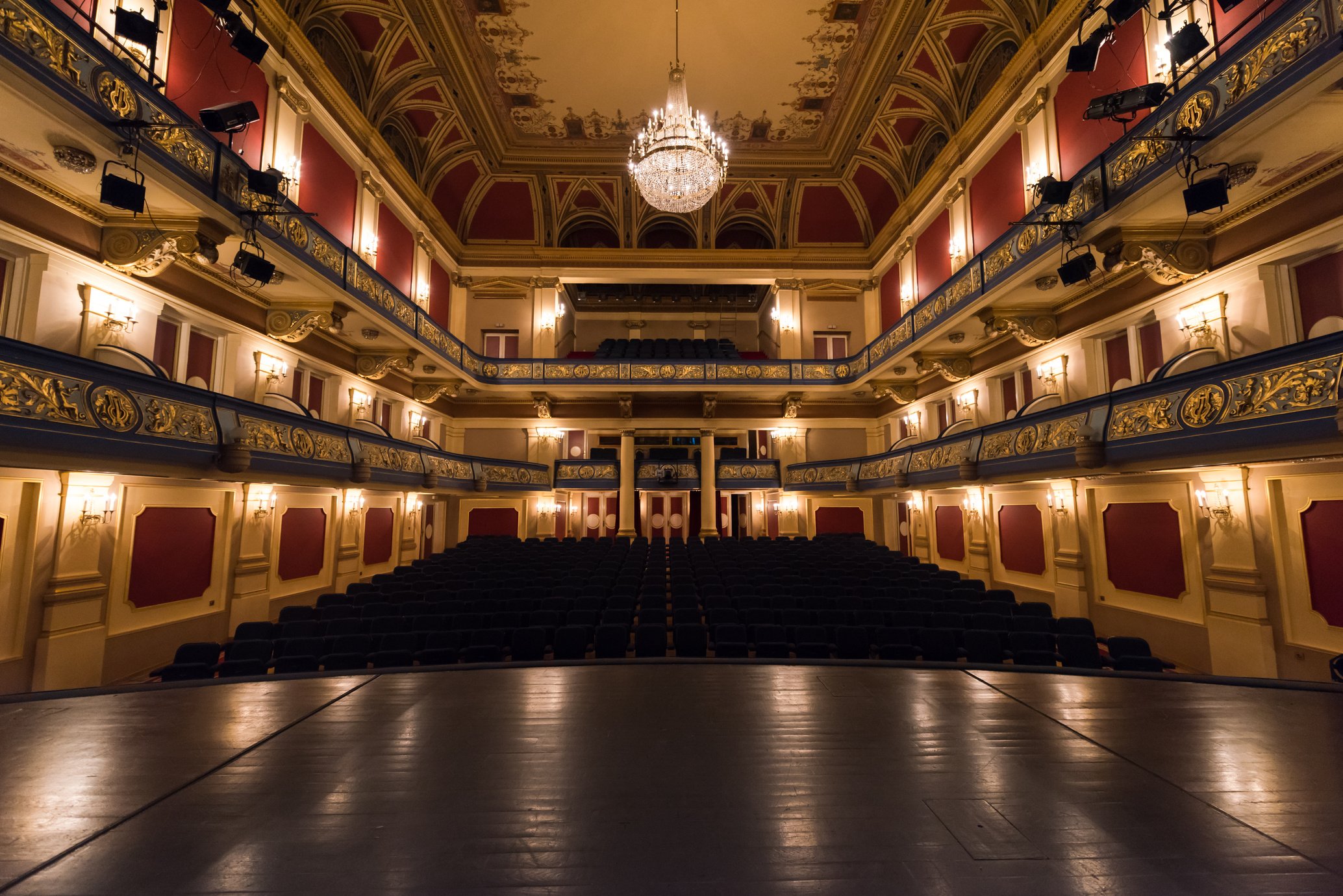 Empty theater stage curtain with dramatic lights